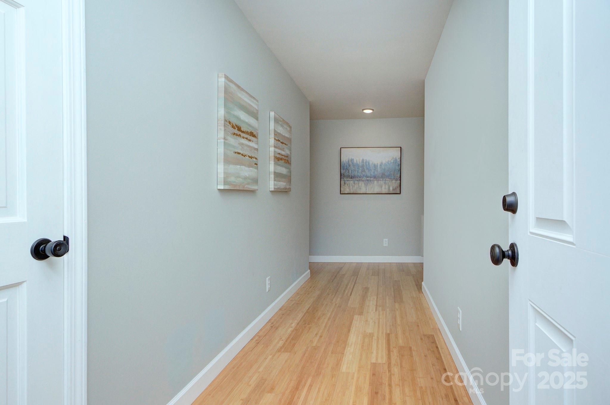 1615 Deer Run Road Catawba, SC 29704 - Photo 6 of 31 a view of a hallway with wooden floor and a bathroom