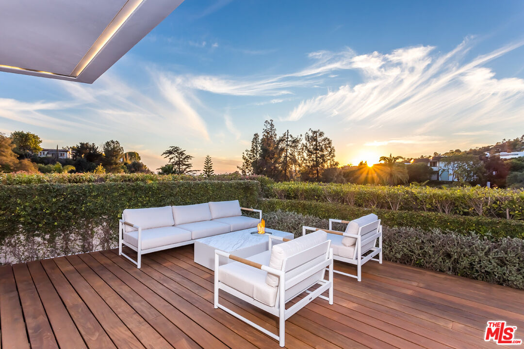 1106 North Hillcrest Road Beverly Hills, CA 90210 - Photo 11 of 54 a view of a lake with couches and wooden floor