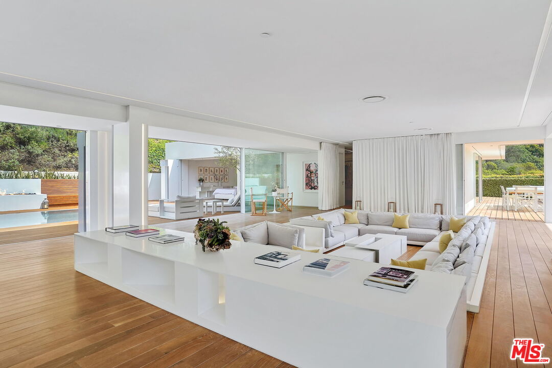 1106 North Hillcrest Road Beverly Hills, CA 90210 - Photo 15 of 54 a living room with furniture and large windows