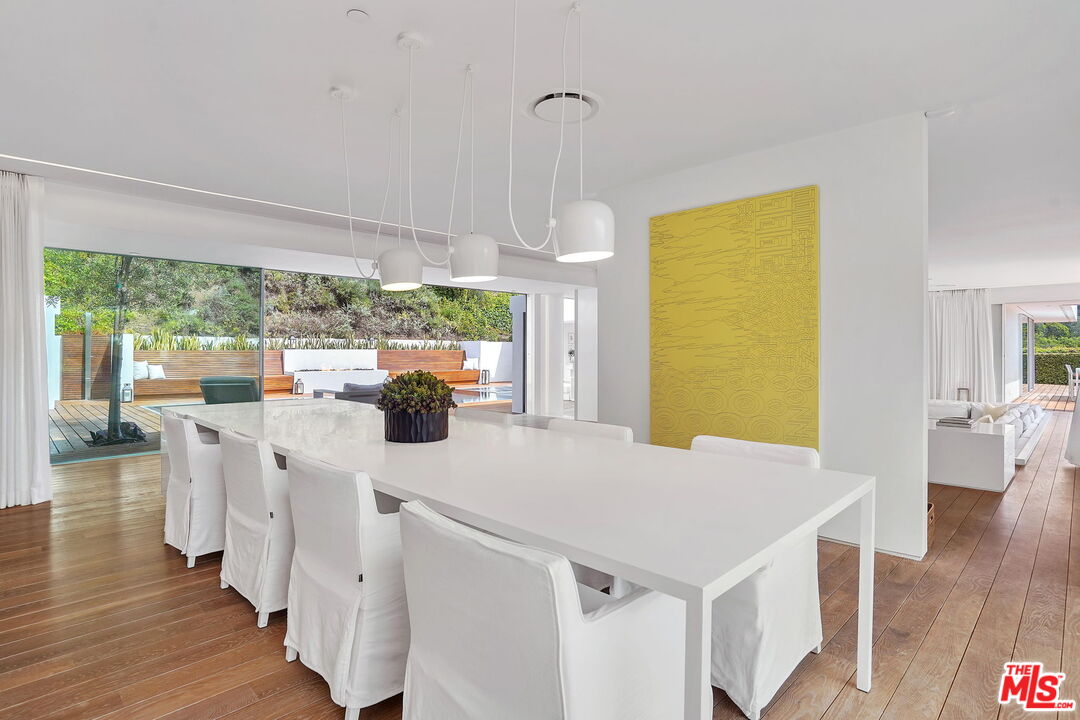 1106 North Hillcrest Road Beverly Hills, CA 90210 - Photo 18 of 54 a view of a kitchen with furniture and wooden floor