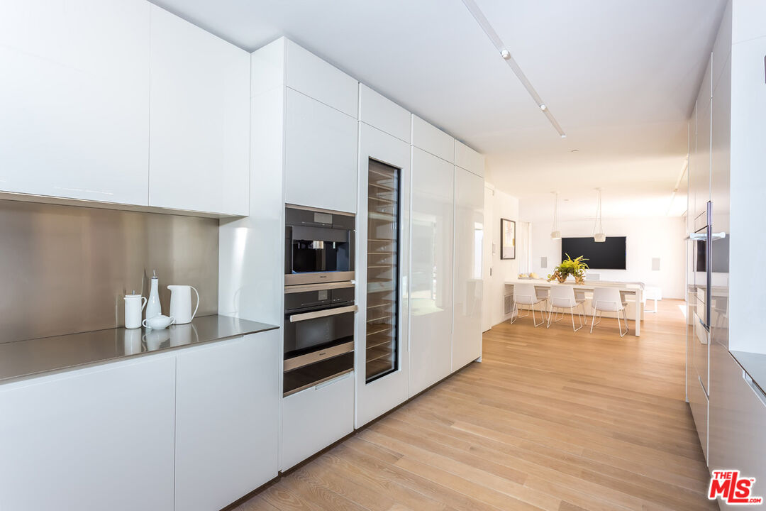 1106 North Hillcrest Road Beverly Hills, CA 90210 - Photo 23 of 54 a view of dining room with furniture and wooden floor