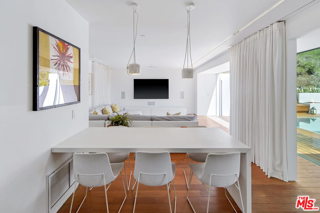 1106 North Hillcrest Road Beverly Hills, CA 90210 - Photo 24 of 54 a view of a dining room with furniture and a window