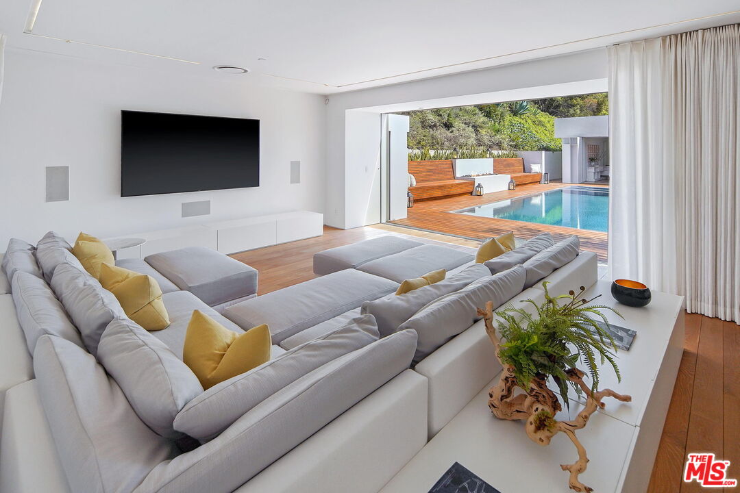 1106 North Hillcrest Road Beverly Hills, CA 90210 - Photo 26 of 54 a living room with furniture and a flat screen tv