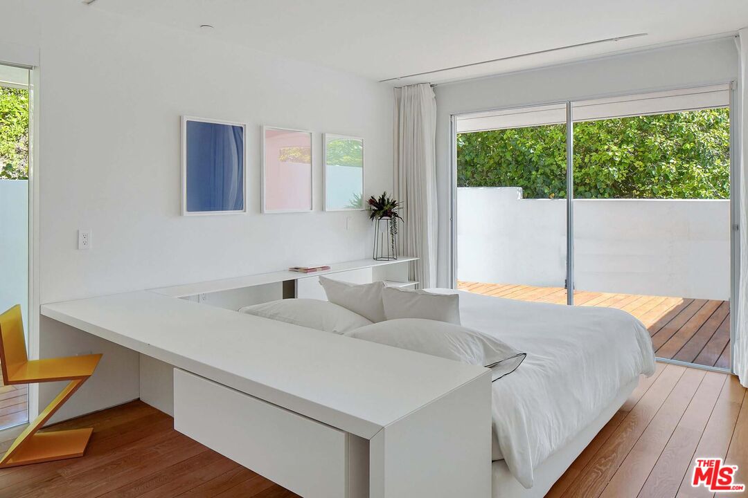 1106 North Hillcrest Road Beverly Hills, CA 90210 - Photo 37 of 54 a bedroom with a bed and a window
