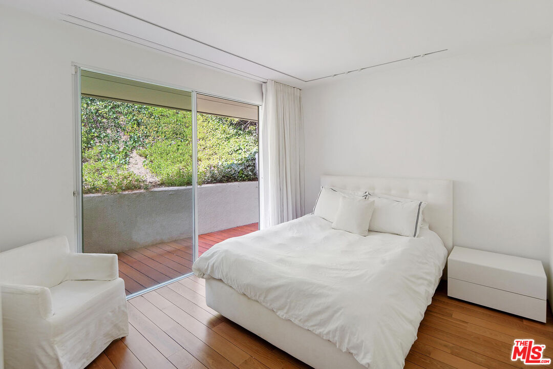 1106 North Hillcrest Road Beverly Hills, CA 90210 - Photo 40 of 54 a bedroom with a bed and a couch