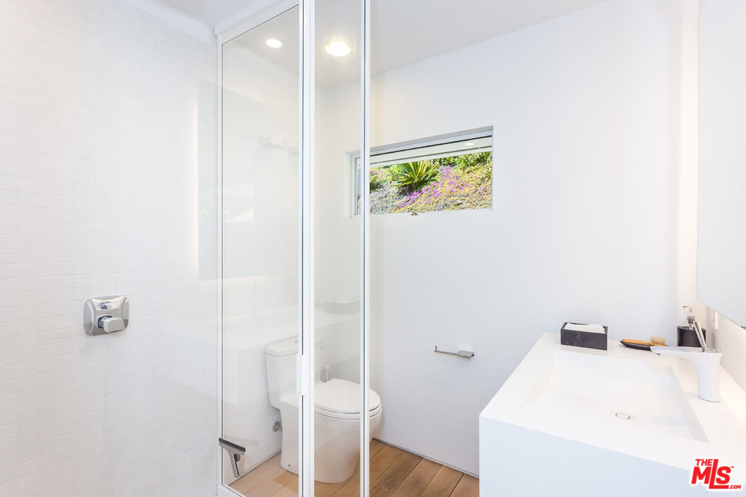 1106 North Hillcrest Road Beverly Hills, CA 90210 - Photo 41 of 54 a bathroom with a sink and a toilet