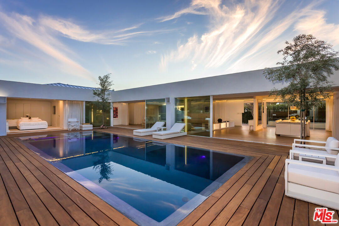 1106 North Hillcrest Road Beverly Hills, CA 90210 - Photo 44 of 54 a view of kitchen island a sink and living room view