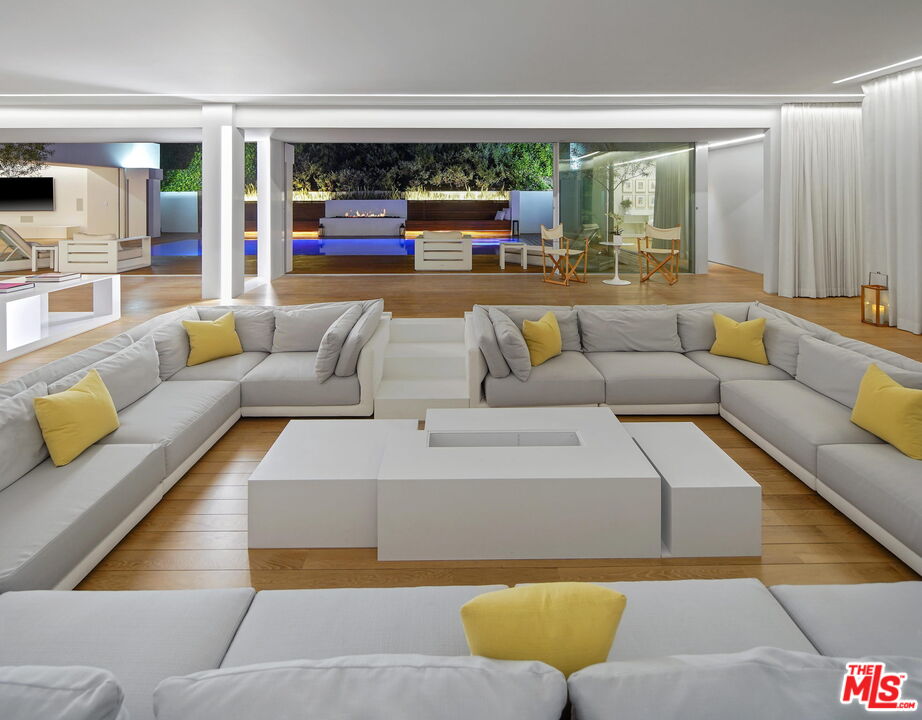 1106 North Hillcrest Road Beverly Hills, CA 90210 - Photo 49 of 54 a living room with furniture and a large window