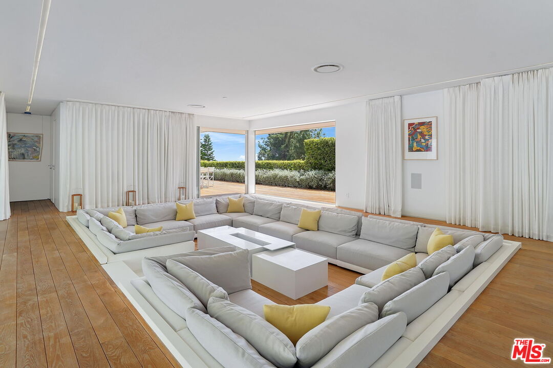 1106 North Hillcrest Road Beverly Hills, CA 90210 - Photo 6 of 54 a living room with furniture and a large window