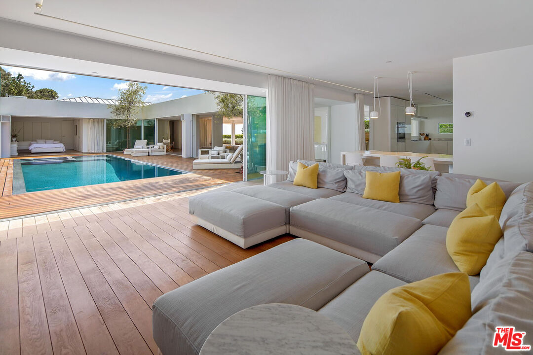1106 North Hillcrest Road Beverly Hills, CA 90210 - Photo 7 of 54 a living room with furniture and a large window
