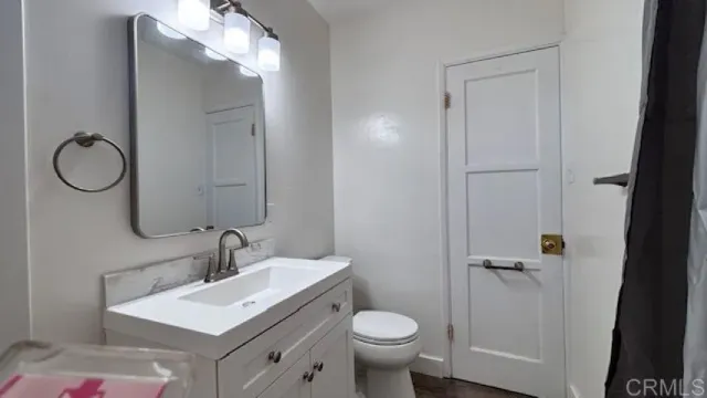 a bathroom with a sink toilet and vanity
