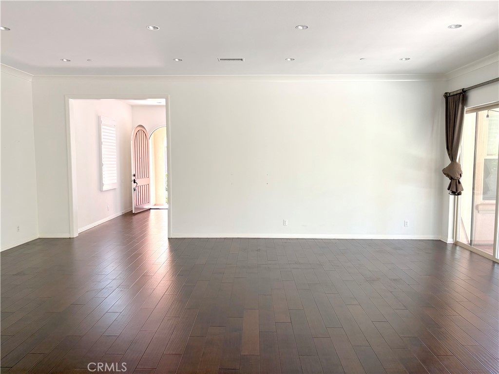 89 Field Poppy Irvine, CA 92620 - Photo 11 of 37 an empty room with wooden floor and windows
