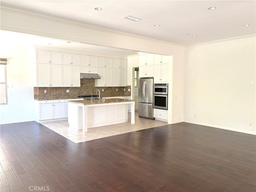 89 Field Poppy Irvine, CA 92620 - Photo 13 of 37 a view of a kitchen with wooden floor