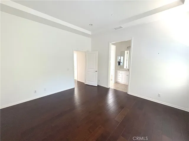 a bathroom with a granite countertop sink a mirror and a shower