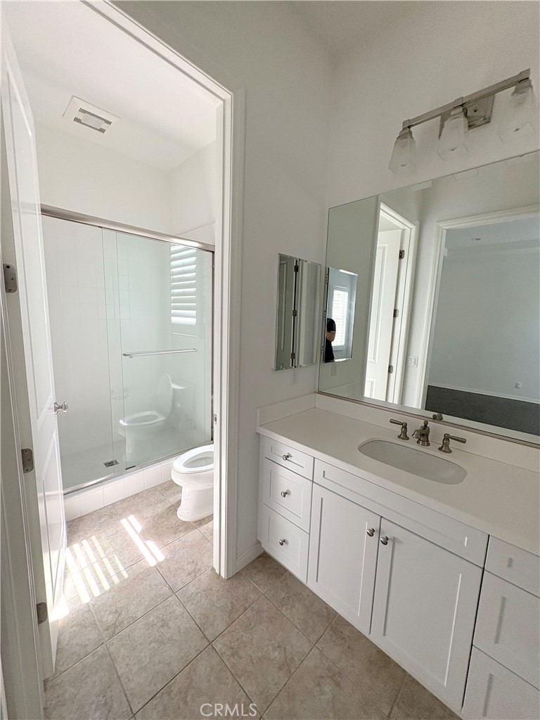 89 Field Poppy Irvine, CA 92620 - Photo 19 of 37 a bathroom with a granite countertop sink a mirror and a shower