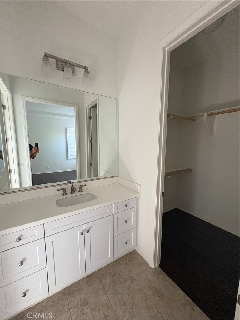 89 Field Poppy Irvine, CA 92620 - Photo 20 of 37 a bathroom with a double vanity sink and mirror