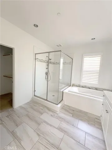 an empty room with windows and mirror