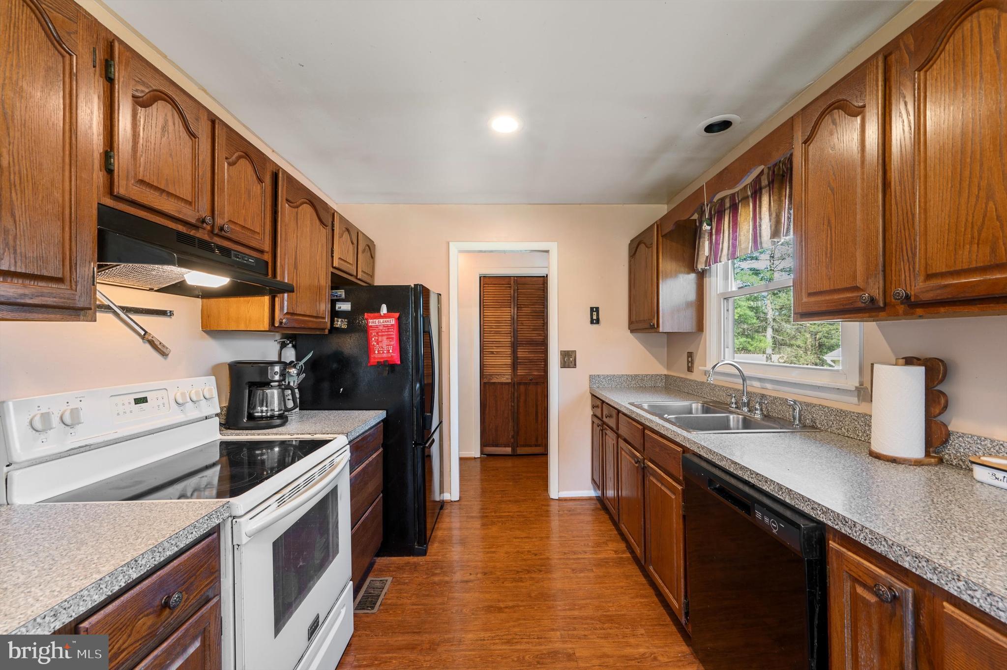 6521 Howellsville Road Front Royal, VA 22630 - Photo 11 of 46 a kitchen with stainless steel appliances granite countertop a stove a sink and a refrigerator