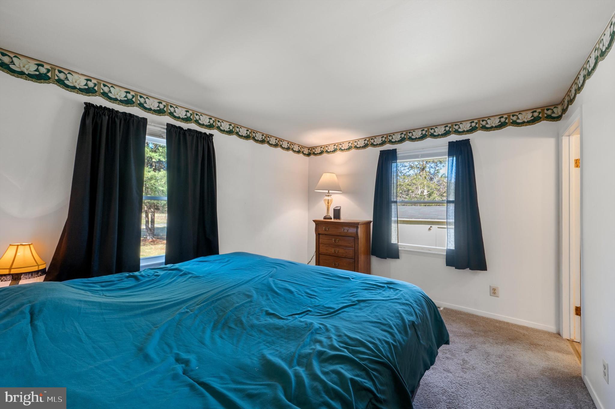 6521 Howellsville Road Front Royal, VA 22630 - Photo 16 of 46 a bed sitting in a bedroom next to a window