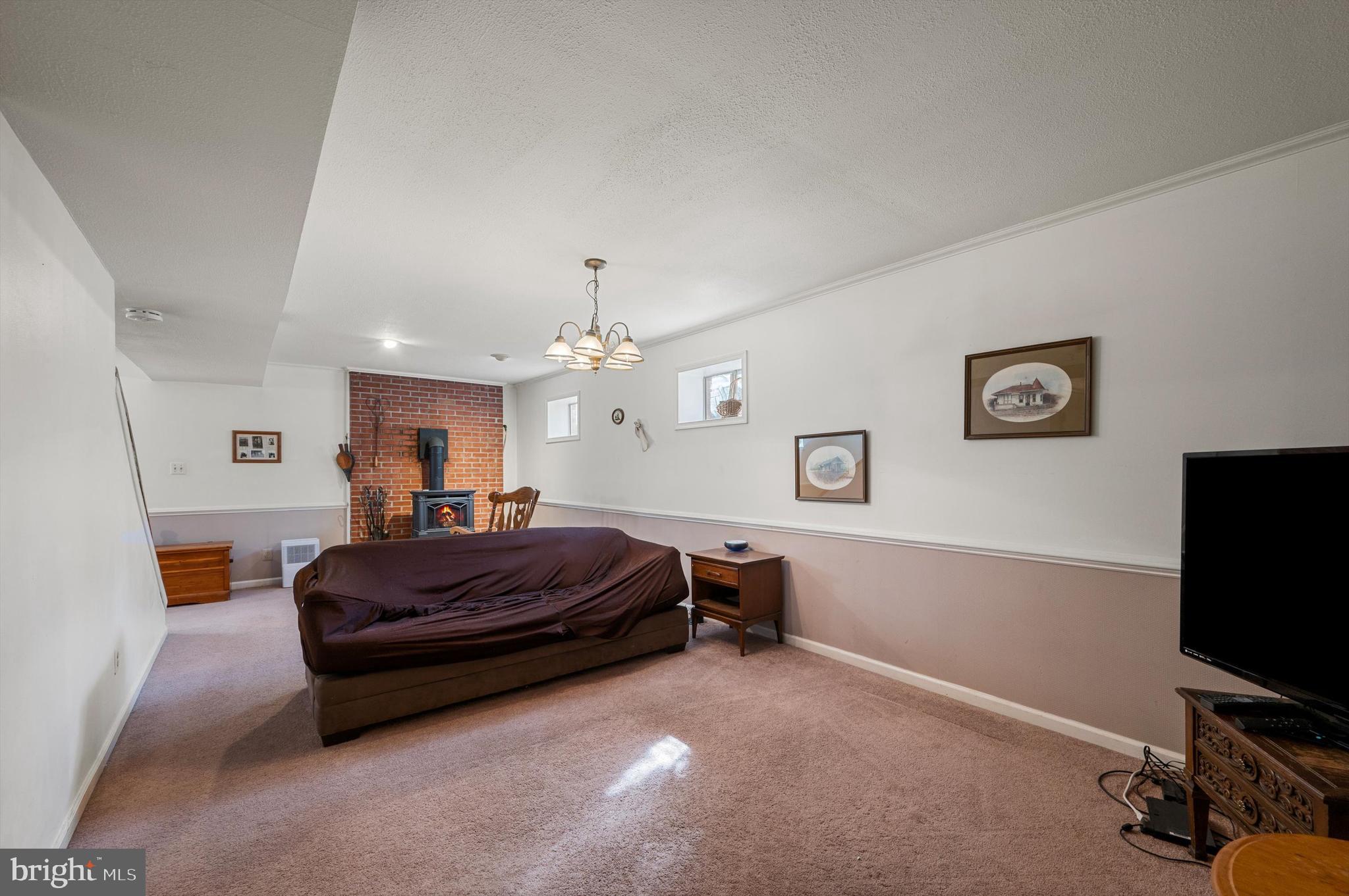 6521 Howellsville Road Front Royal, VA 22630 - Photo 26 of 46 a spacious bedroom with a bed and a flat screen tv
