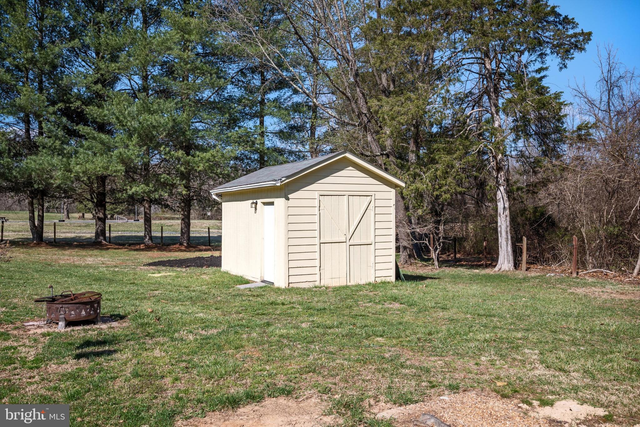 6521 Howellsville Road Front Royal, VA 22630 - Photo 36 of 46 a white house with a small yard and large trees