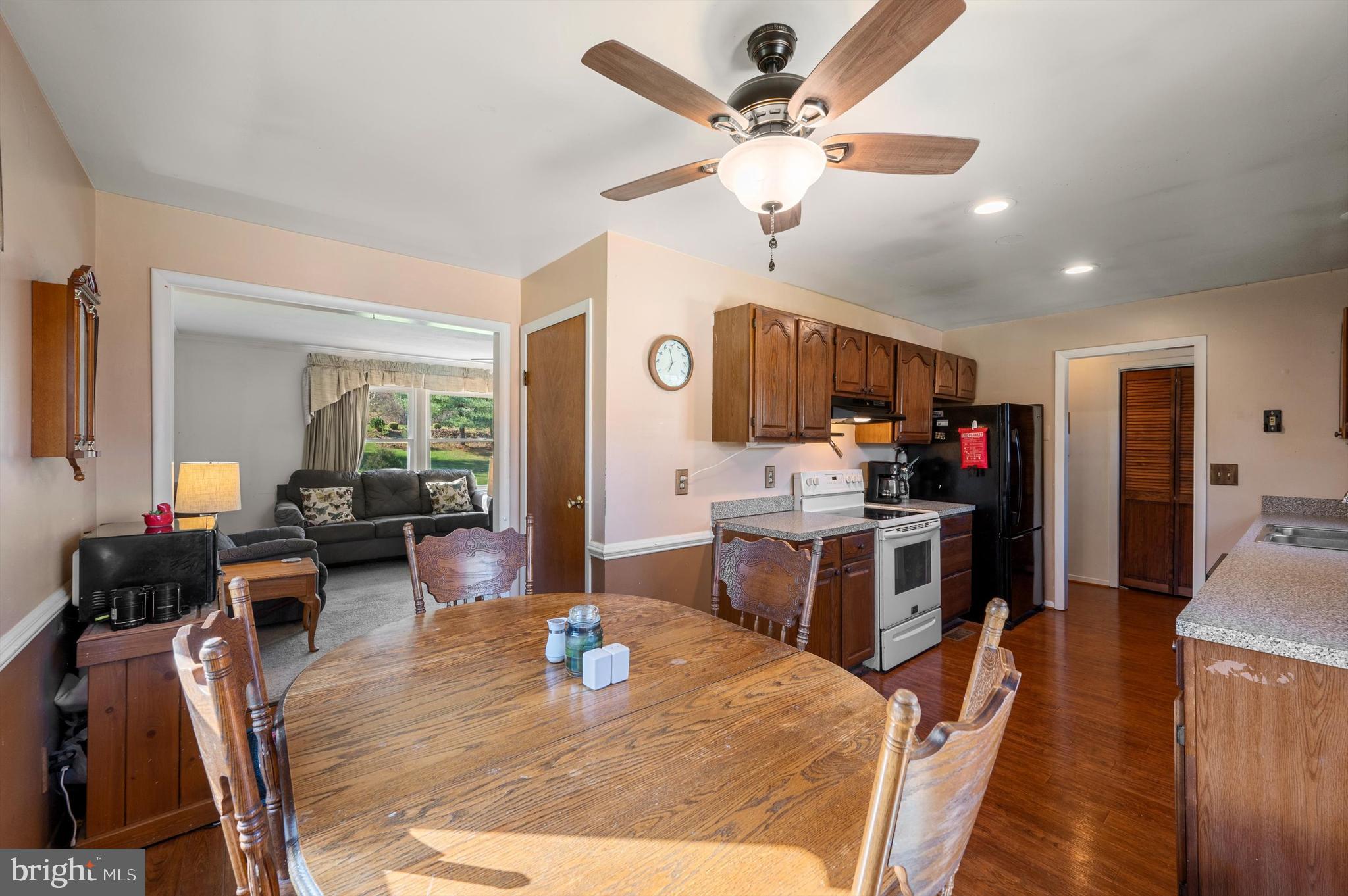 6521 Howellsville Road Front Royal, VA 22630 - Photo 8 of 46 a living room with furniture kitchen view and a wooden floor