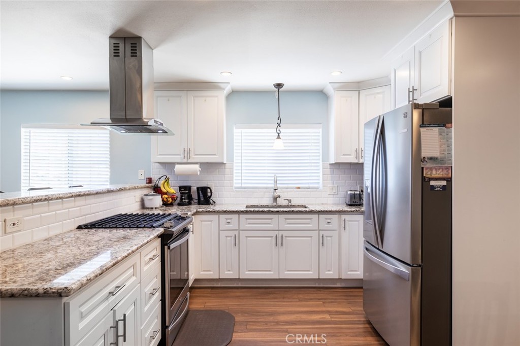 5512 Marcella Avenue Cypress, CA 90630 - Photo 16 of 39 a kitchen with stainless steel appliances granite countertop a sink stove and refrigerator