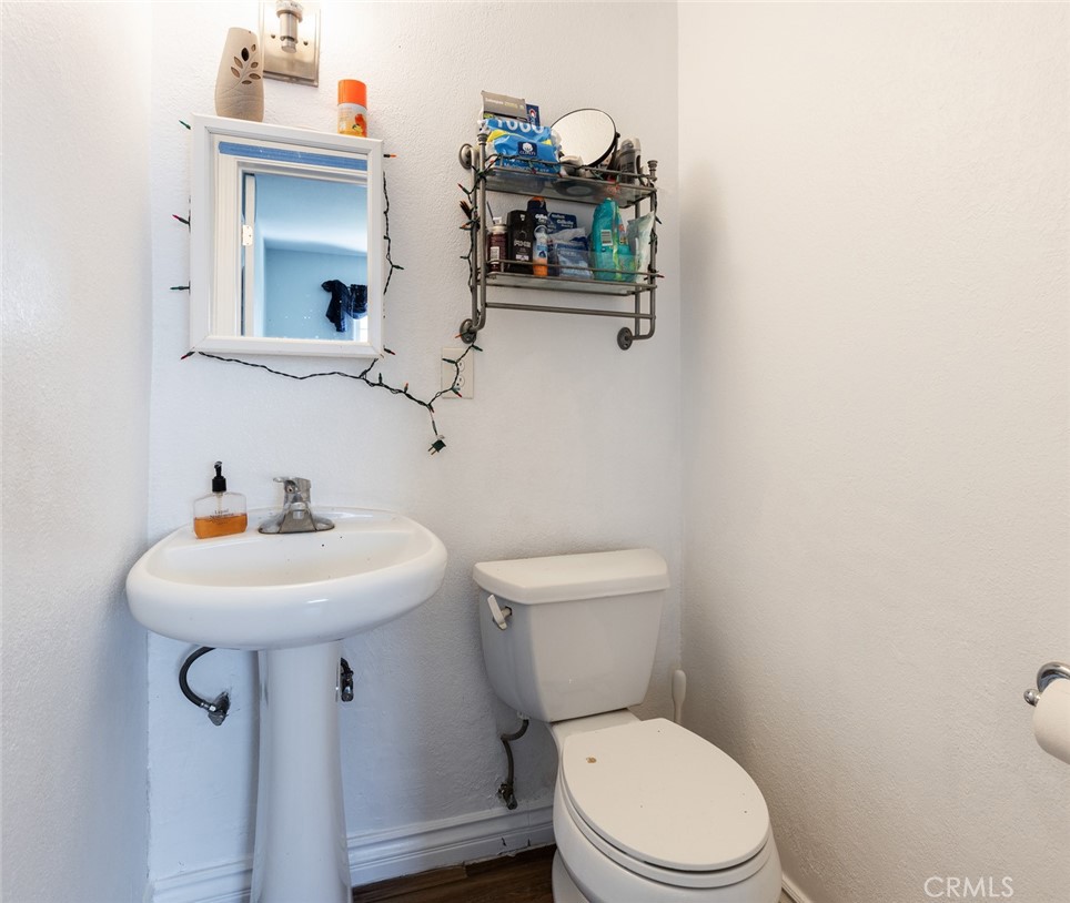 5512 Marcella Avenue Cypress, CA 90630 - Photo 33 of 39 a bathroom with a sink toilet and mirror
