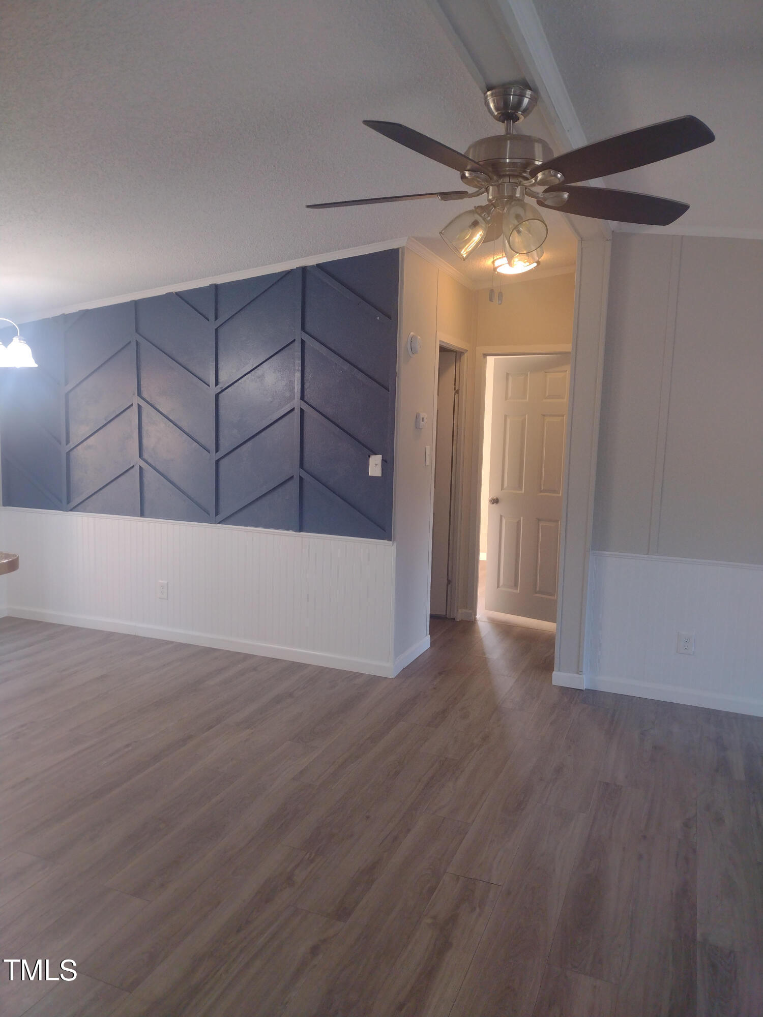 437 West Northpoint Road Spring Lake, NC 28390 - Photo 5 of 27 a view of an empty room with wooden floor and a ceiling fan