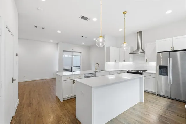 a bathroom with a sink a toilet a mirror and shower