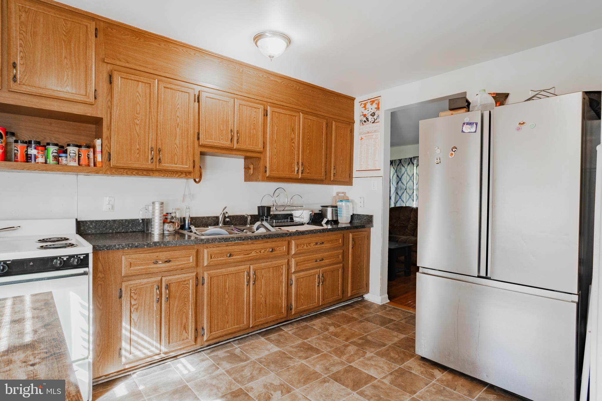 824 Gunnison Road York, PA 17404 - Photo 6 of 16 a kitchen with stainless steel appliances granite countertop a refrigerator sink and cabinets