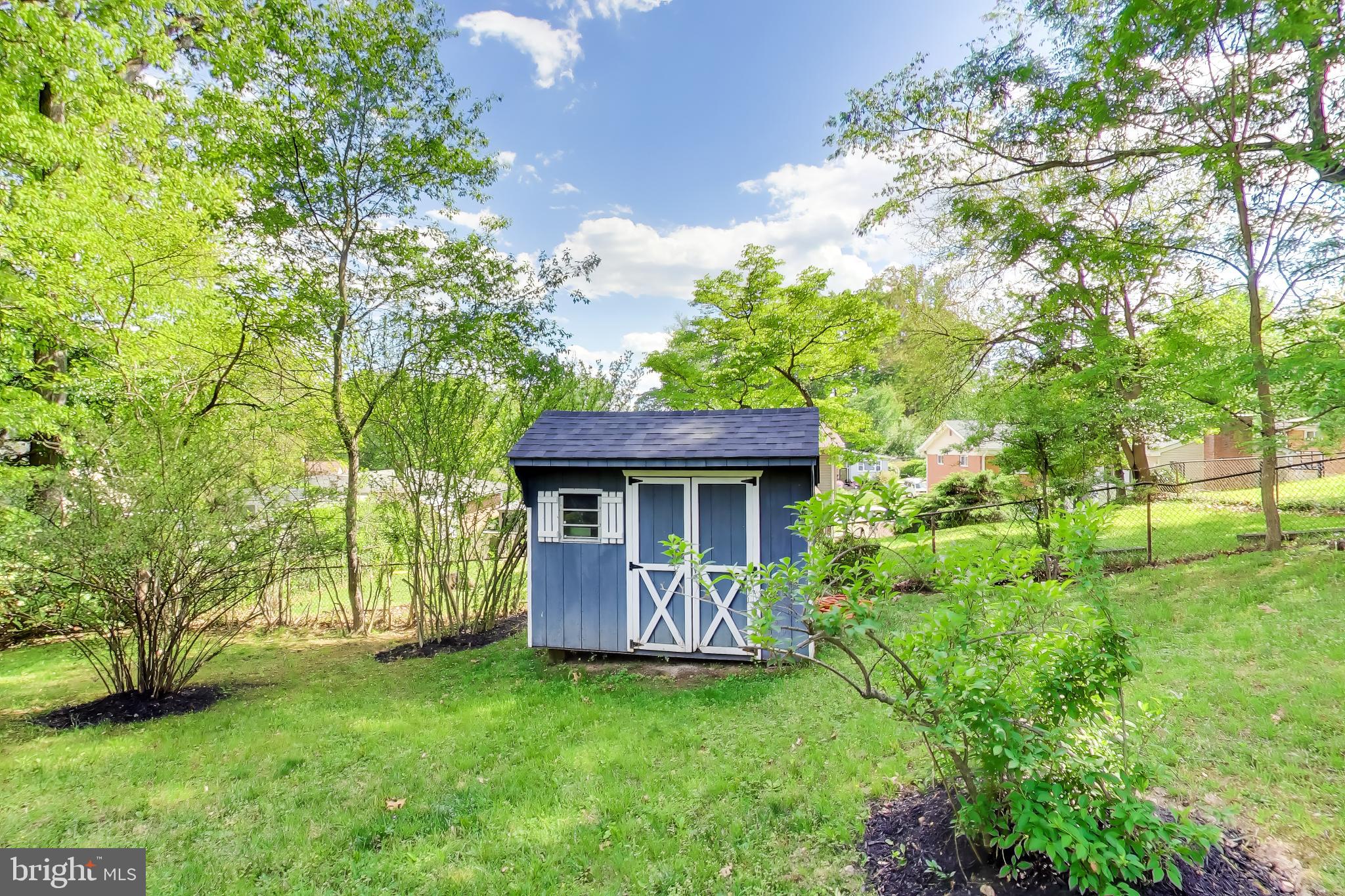 810 Malta Lane Silver Spring, MD 20901 - Photo 35 of 35 Charming garden shed in lush greenery.
