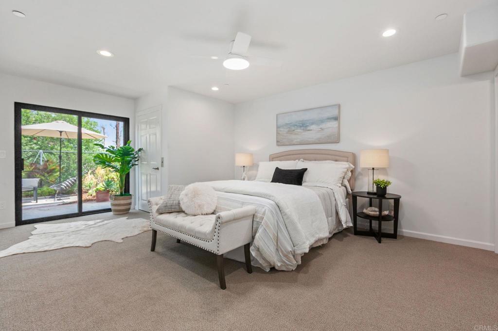 597 Via Cantebria Encinitas, CA 92024 - Photo 26 of 41 a spacious bedroom with a bed and a couch