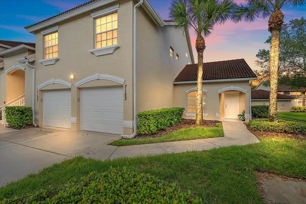 a front view of a house with a yard and garage