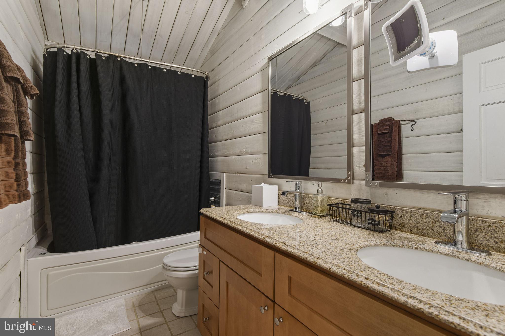 137 Plum Point Road Elkton, MD 21921 - Photo 15 of 54 a bathroom with a granite countertop bathtub sink vanity mirror and toilet