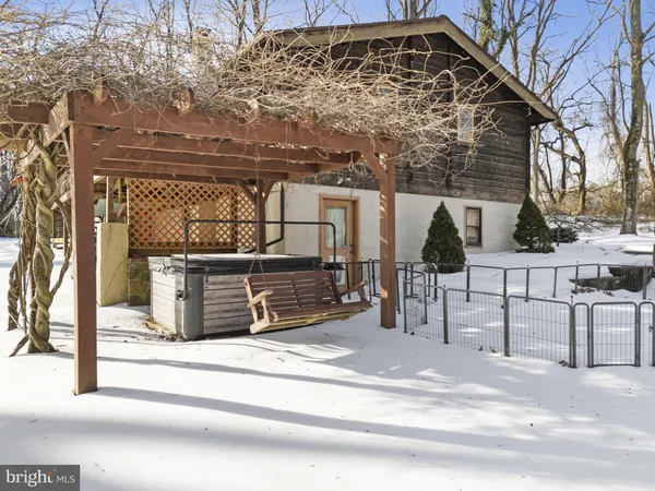 a view of a house with a wooden fence