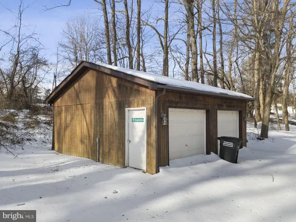 a front view of a house with fire pit and couches