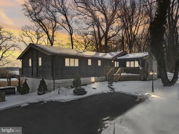 a view of a house with snow on the road