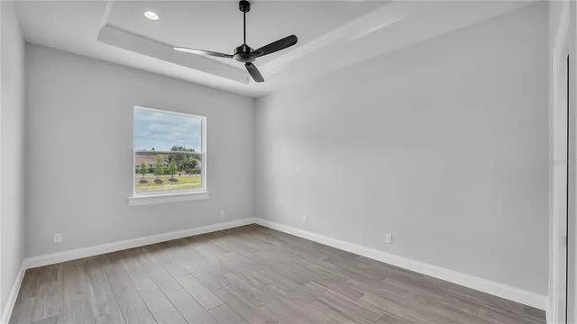 a view of an empty room with a ceiling fan