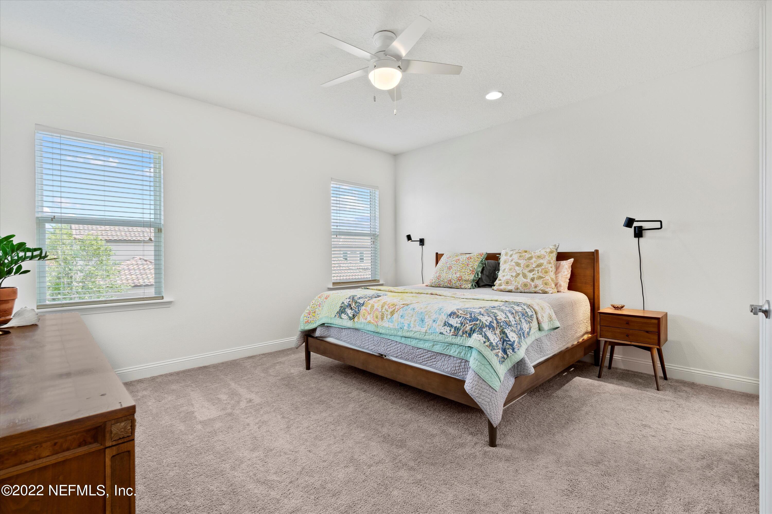 245 Rialto Drive Ponte Vedra, FL 32081 - Photo 18 of 29 a bedroom with a bed ceiling fan and a window