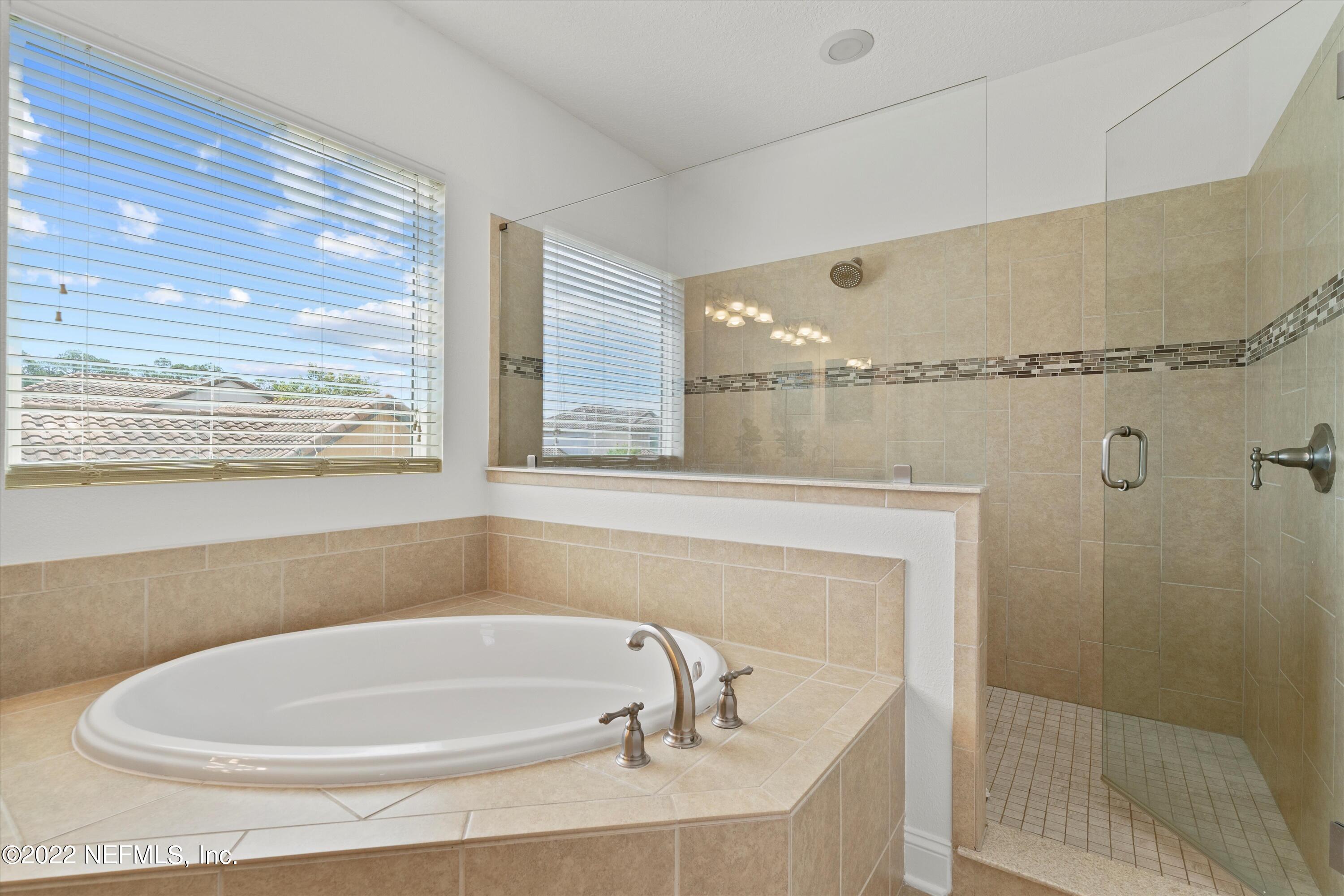 245 Rialto Drive Ponte Vedra, FL 32081 - Photo 21 of 29 a bathroom with a white bath tub sitting next to a window