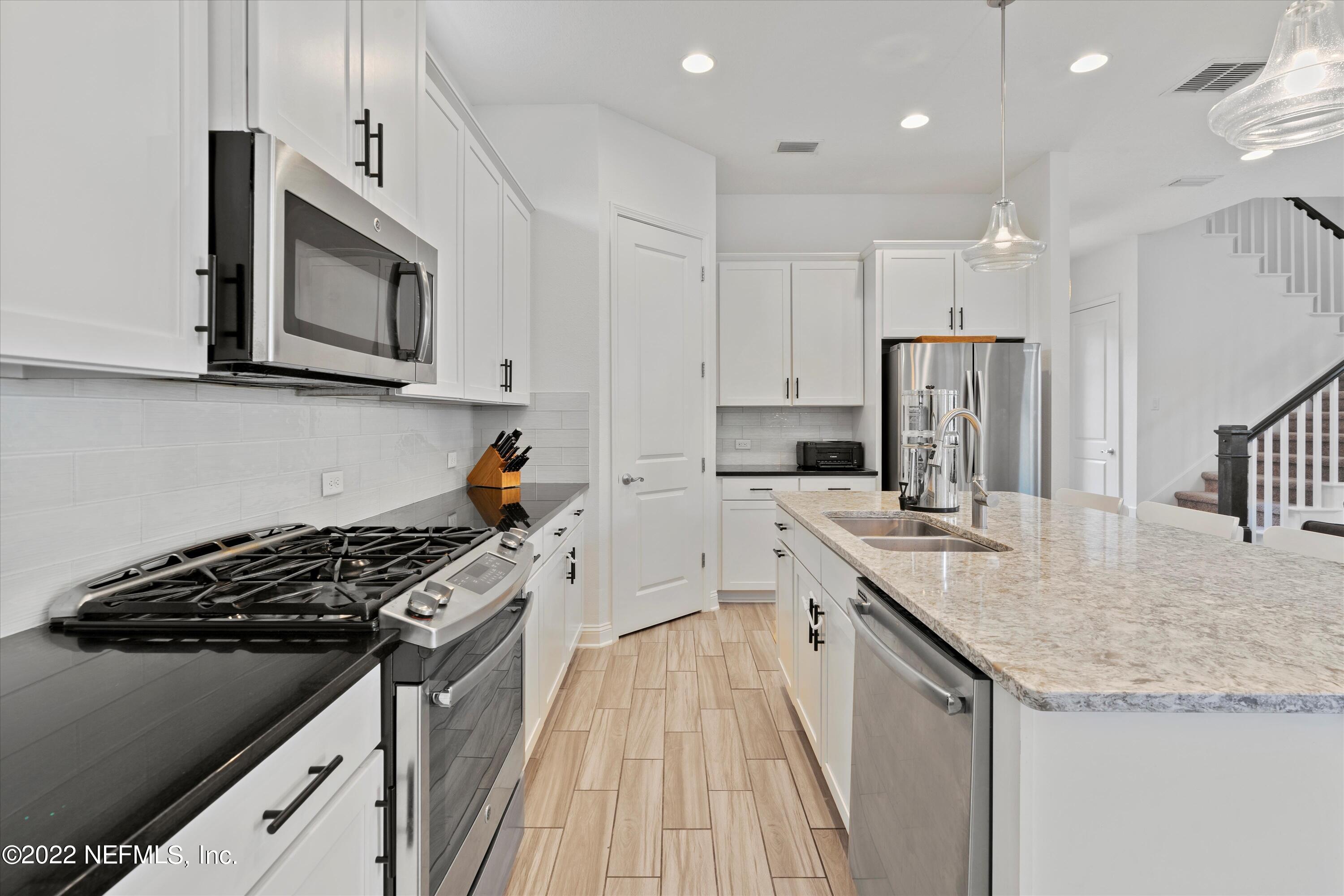 245 Rialto Drive Ponte Vedra, FL 32081 - Photo 10 of 29 a kitchen with stainless steel appliances sink stove microwave and cabinets