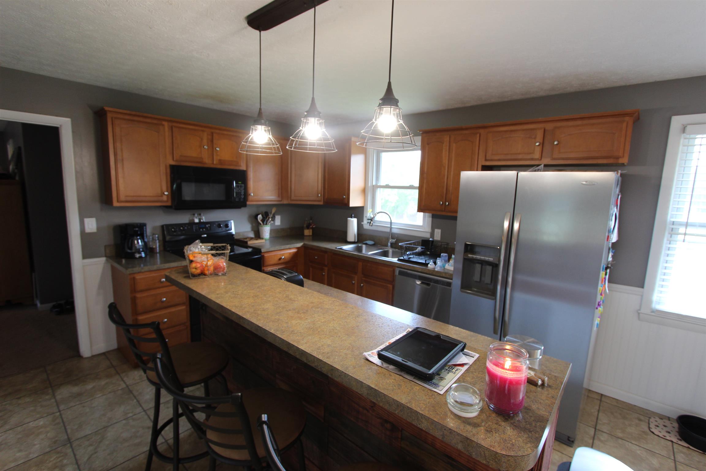 4240 Simmons Bluff Road Lebanon, TN 37090 - Photo 8 of 30 a kitchen with stainless steel appliances granite countertop a refrigerator a sink a stove and a wooden cabinets