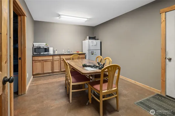 a dining room with furniture and a window