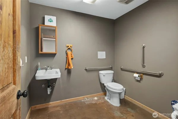 a bathroom with a toilet sink and mirror