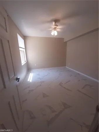 an empty room with stairs and wooden floor
