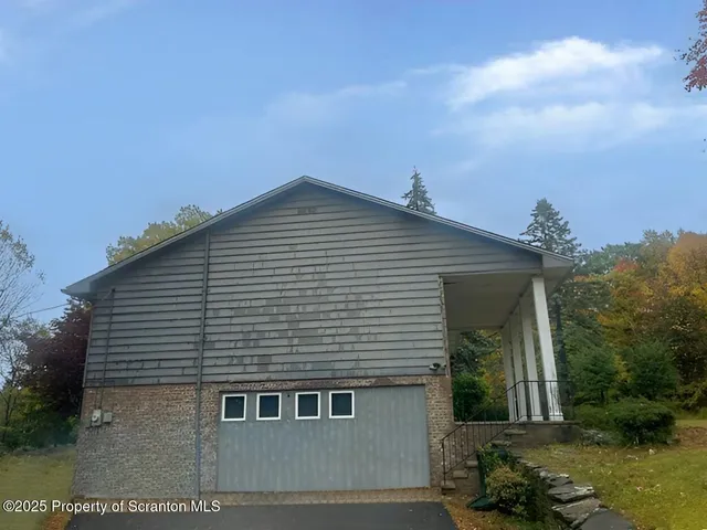 a view of a field with trees in background