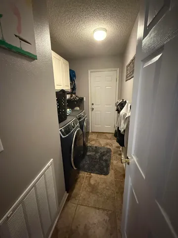 a view of a house with a garden and sitting area