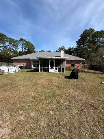 a view of a swimming pool and trees in the background