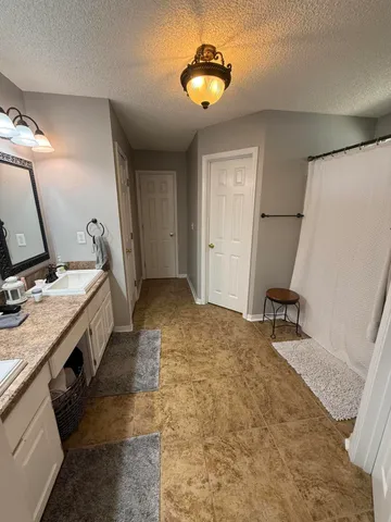 a view of a hallway to a livingroom with furniture